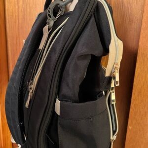 Baby diaper bookbag with changing pad pull out.